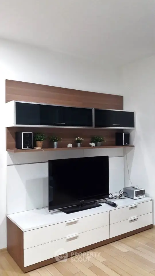 Modern living room with sleek TV unit and stylish shelving, perfect for contemporary home entertainment.