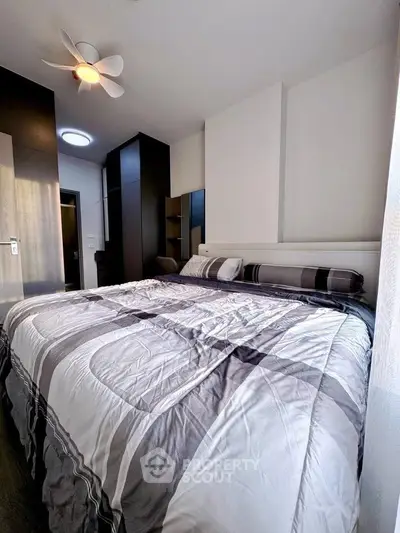 Modern bedroom with stylish decor and ample natural light