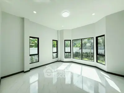 Spacious living room with large windows and garden view