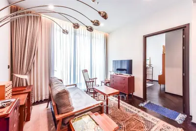 Charming living room with modern decor and natural light, featuring stylish furniture and a cozy ambiance.