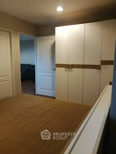 Spacious bedroom with modern wardrobe and cozy lighting