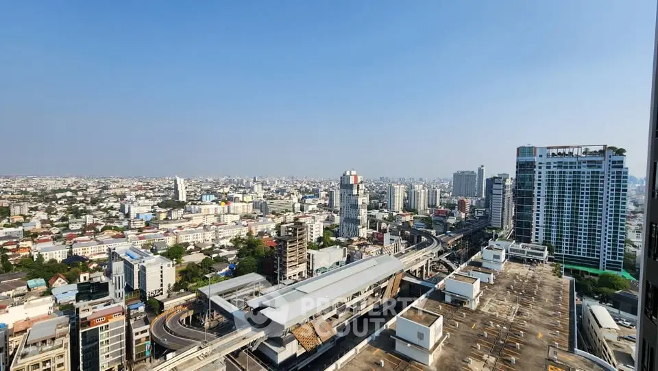 Stunning cityscape view from a high-rise building showcasing urban skyline and transportation hub.