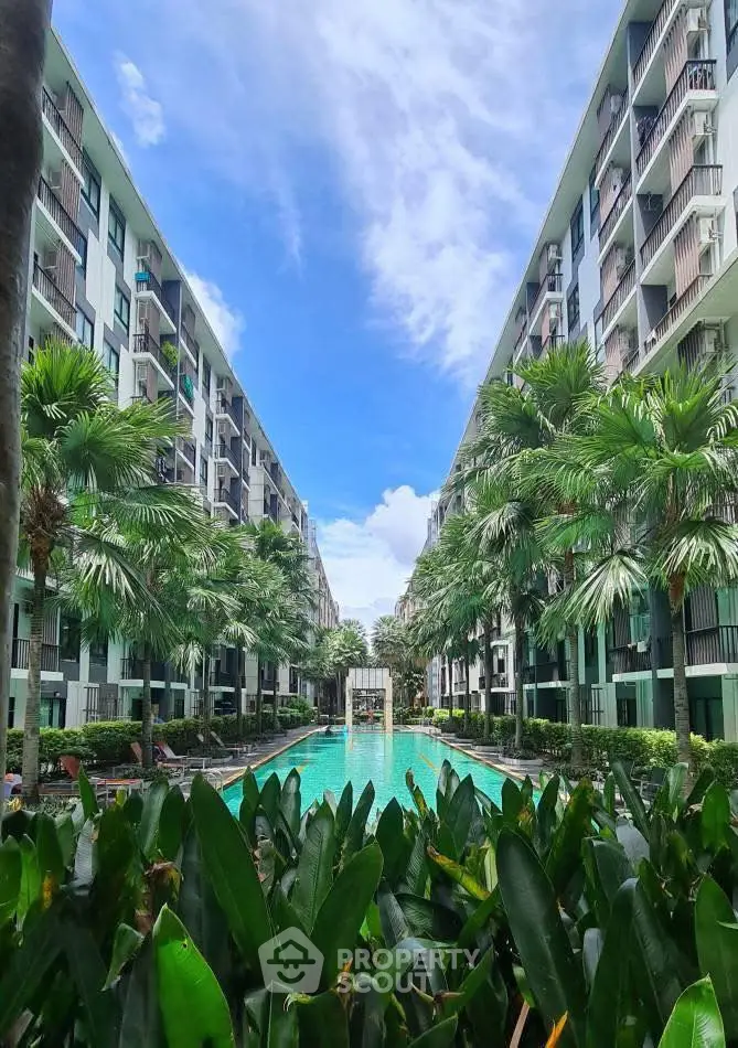 Luxurious apartment complex with stunning pool and lush greenery
