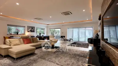 Luxurious spacious living room with modern decor and large windows.