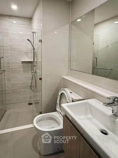 Modern bathroom with sleek design, glass shower, and contemporary fixtures.