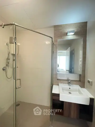 Modern bathroom with glass shower and sleek sink design