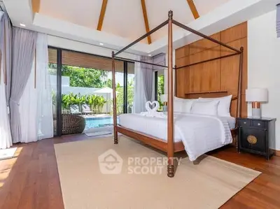 Luxurious bedroom with pool view, elegant four-poster bed, and stylish decor in a serene setting.