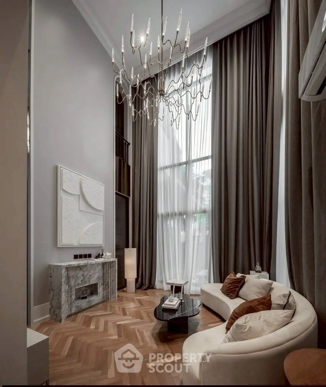 Luxurious living room with high ceilings, elegant chandelier, and modern decor in a sophisticated apartment.