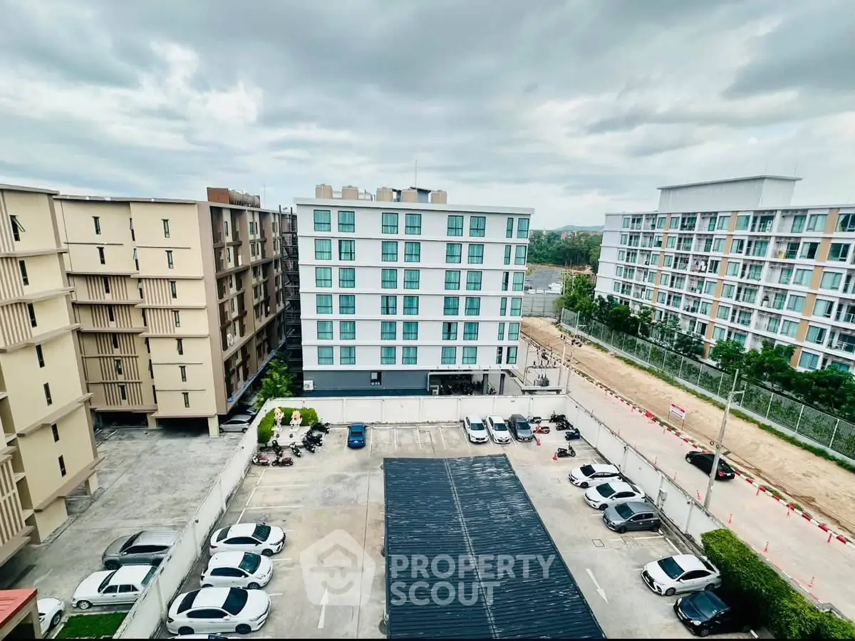 Modern apartment complex with spacious parking area and contemporary design.