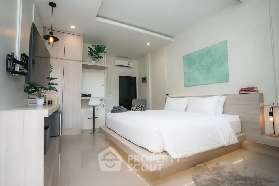 Modern bedroom with sleek design, featuring a cozy bed, ambient lighting, and stylish decor.