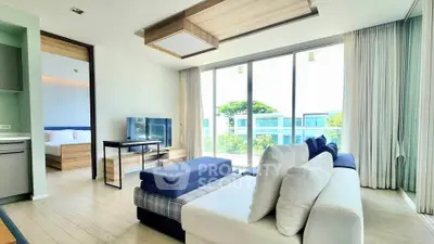Modern living room with large windows and stylish furniture in a bright apartment.