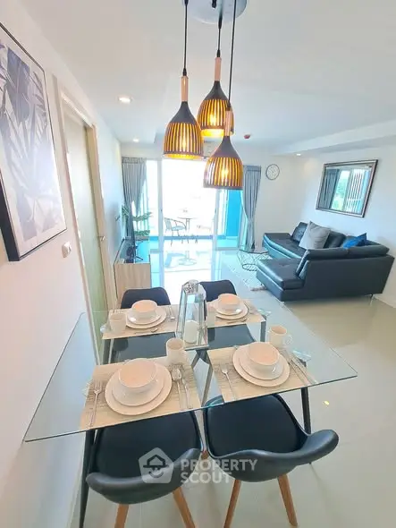 Modern living room with stylish dining area and balcony view