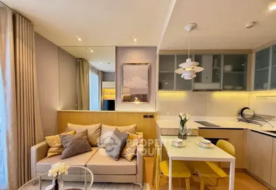 Modern open-layout living room and kitchen with stylish decor and cozy ambiance.