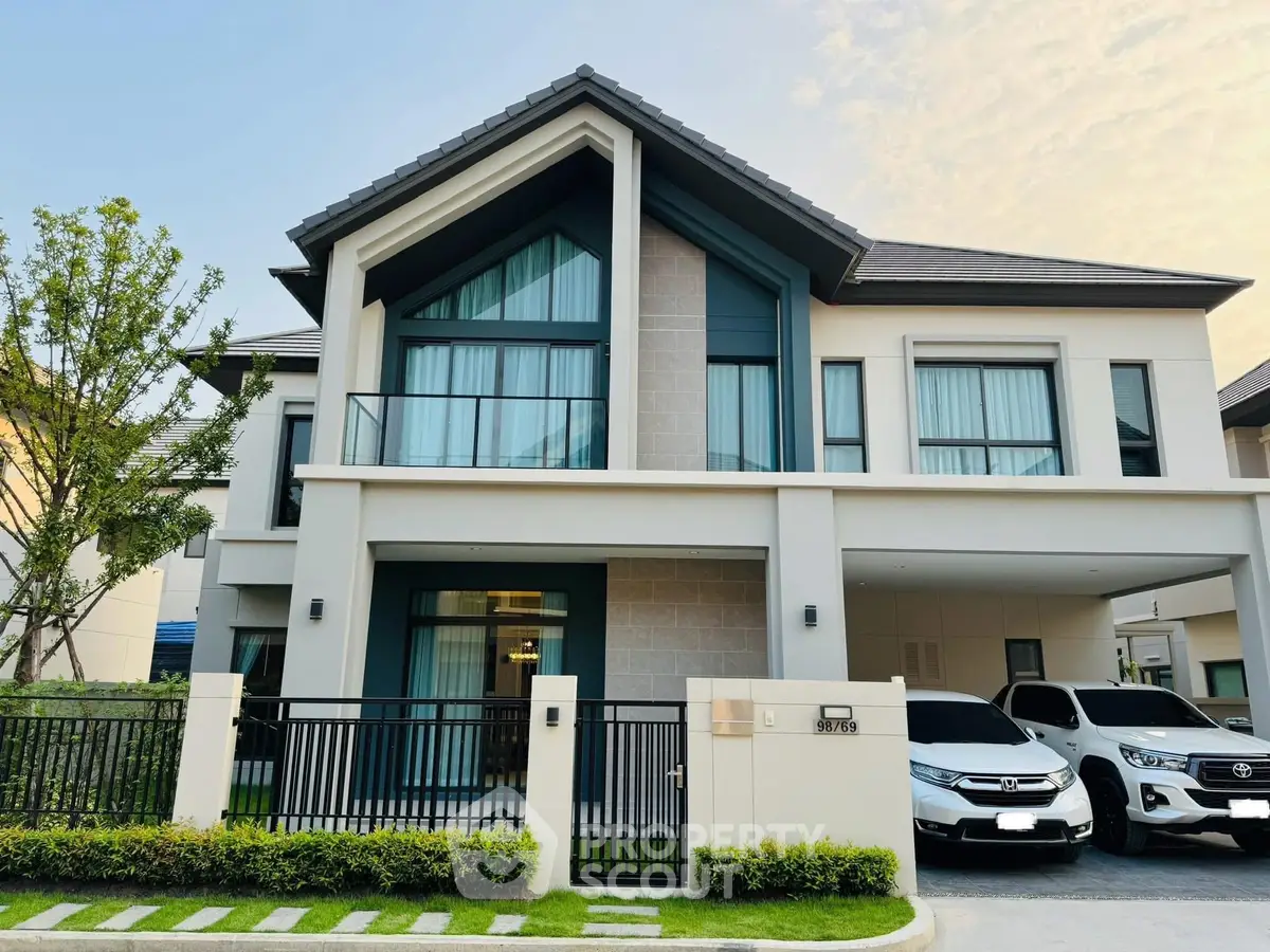 Modern two-story house with sleek design and spacious driveway in a serene neighborhood.
