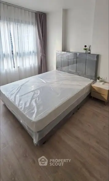 Modern bedroom with large window and minimalist decor