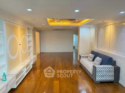 Spacious living room with elegant wood flooring and modern ceiling design