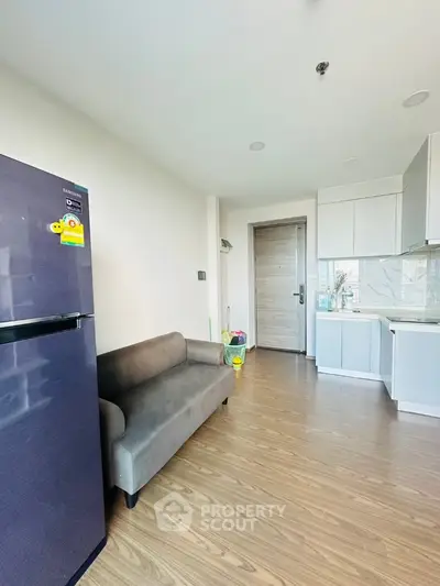 Modern apartment interior with compact kitchen and cozy living area