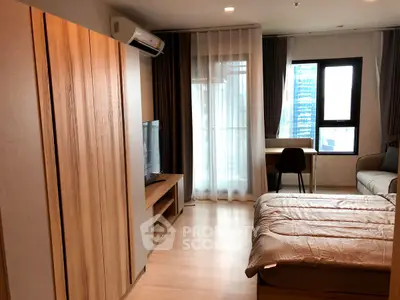 Modern bedroom with wooden furniture, large window, and cozy ambiance in urban apartment.