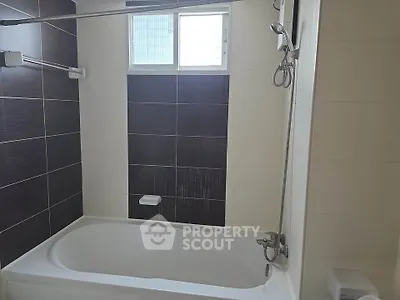 Modern bathroom with sleek bathtub and stylish tile design