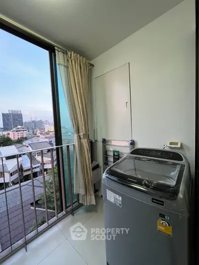 Modern apartment balcony with washing machine and city view