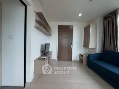 Modern living room with sleek wooden furniture and blue sofa