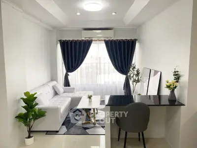 Modern living room with white sofa, elegant curtains, and stylish decor