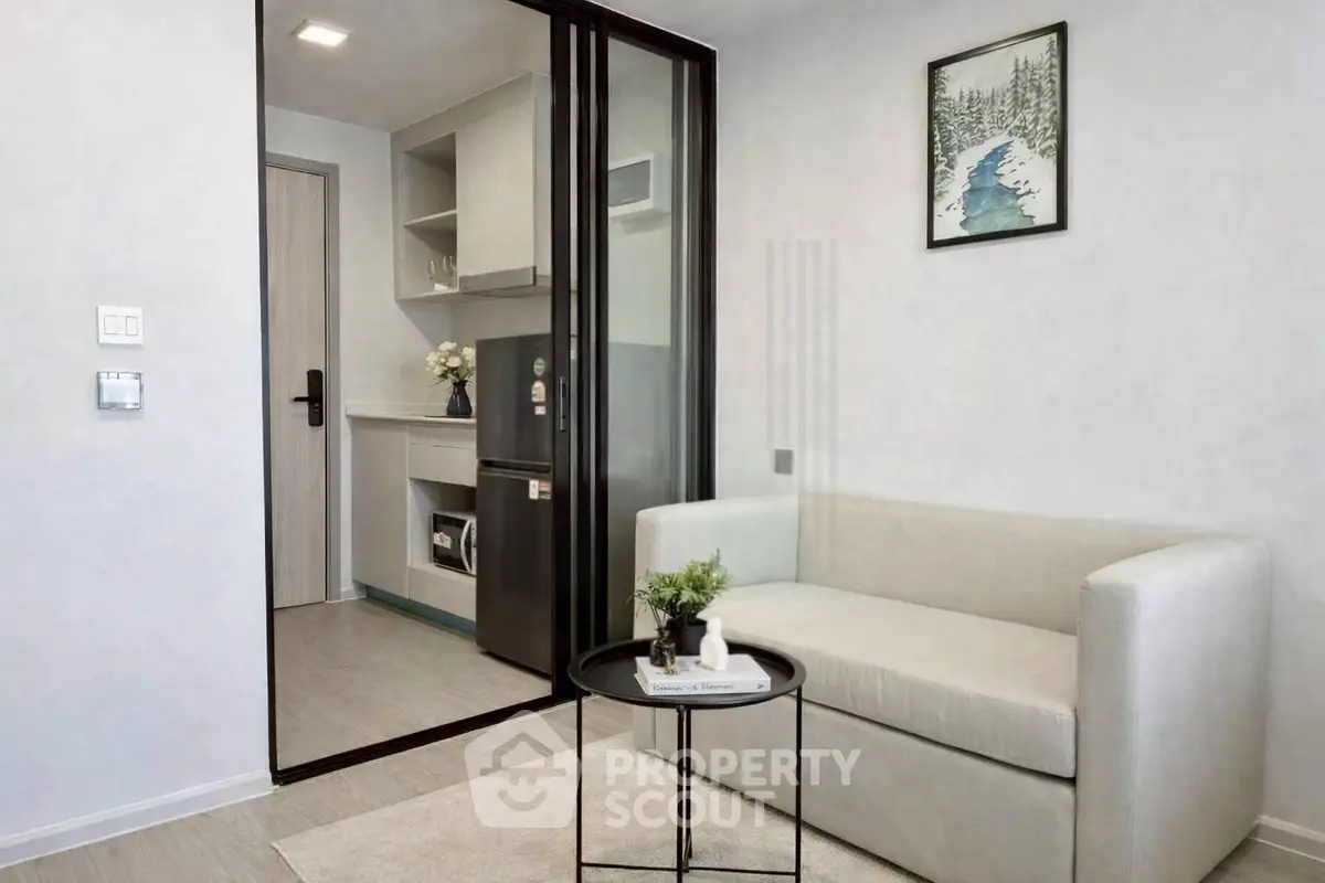 Modern living room with sleek design and compact kitchen area