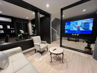 Modern living room with sleek design, featuring a large TV, elegant furniture, and stylish decor.