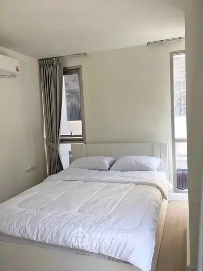 Cozy bedroom with natural light and modern decor in a stylish apartment.