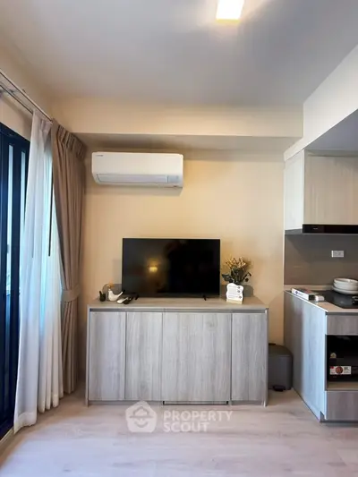 Modern living room with sleek TV cabinet and air conditioning, featuring a cozy and inviting atmosphere.