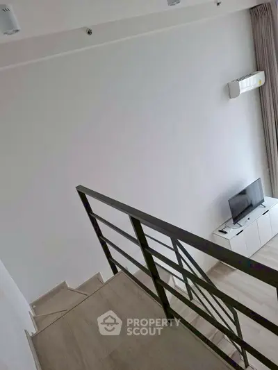Modern duplex interior with sleek staircase and minimalist decor