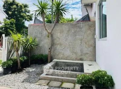 Charming outdoor garden with small pool and lush greenery, perfect for relaxation and tranquility.