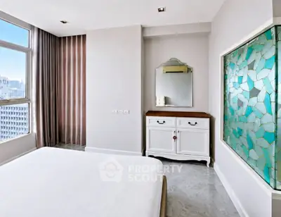 Elegant bedroom with large window and stylish decor in modern apartment