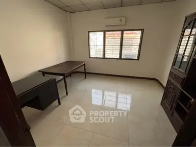 Spacious study room with natural light and tiled flooring