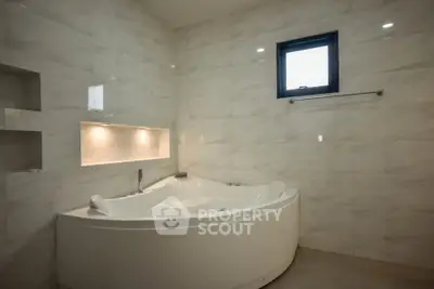Luxurious bathroom with elegant corner bathtub and modern tile design