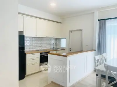 Bright modern kitchen with white cabinets and subway tile backsplash