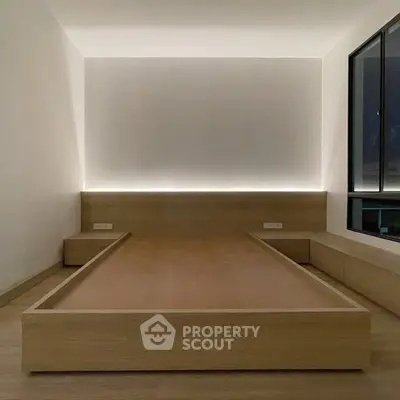 Minimalist bedroom with modern wooden platform bed and ambient lighting