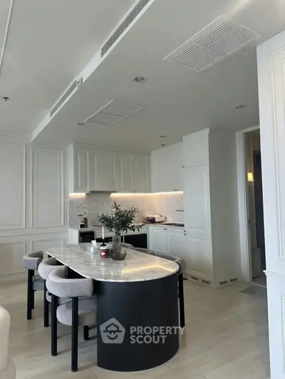 Luxurious modern kitchen with marble countertops and elegant dining area