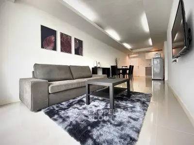 Modern living room with sleek furniture and open kitchen layout