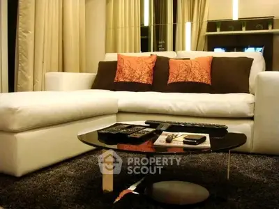 Modern living room with stylish sofa and sleek coffee table in a cozy setting.
