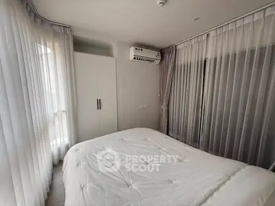 Bright and airy bedroom with modern air conditioning and ample natural light.