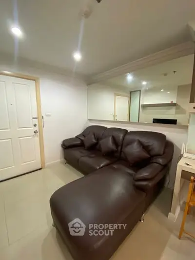 Cozy living room with brown leather sofa and modern decor