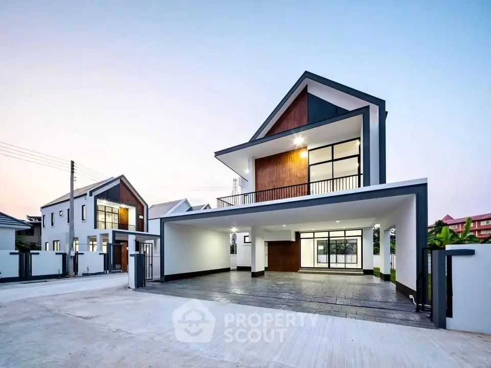 Modern two-story house with spacious driveway and sleek architectural design.