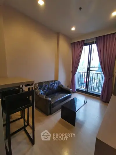 Cozy living room with modern furniture and balcony view in urban apartment