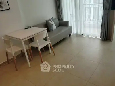 Modern living room with sleek furniture and natural light, perfect for cozy gatherings.