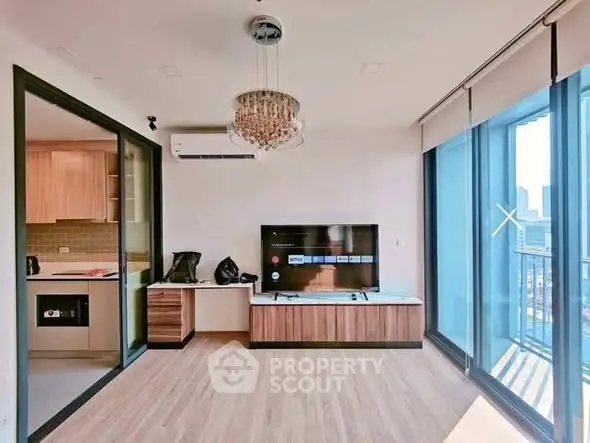Modern living room with open kitchen and city view balcony in luxury apartment.