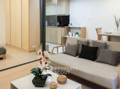 Modern open-plan living room with sleek kitchen and stylish decor