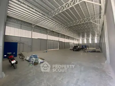 Spacious industrial warehouse with high ceilings and ample storage space.