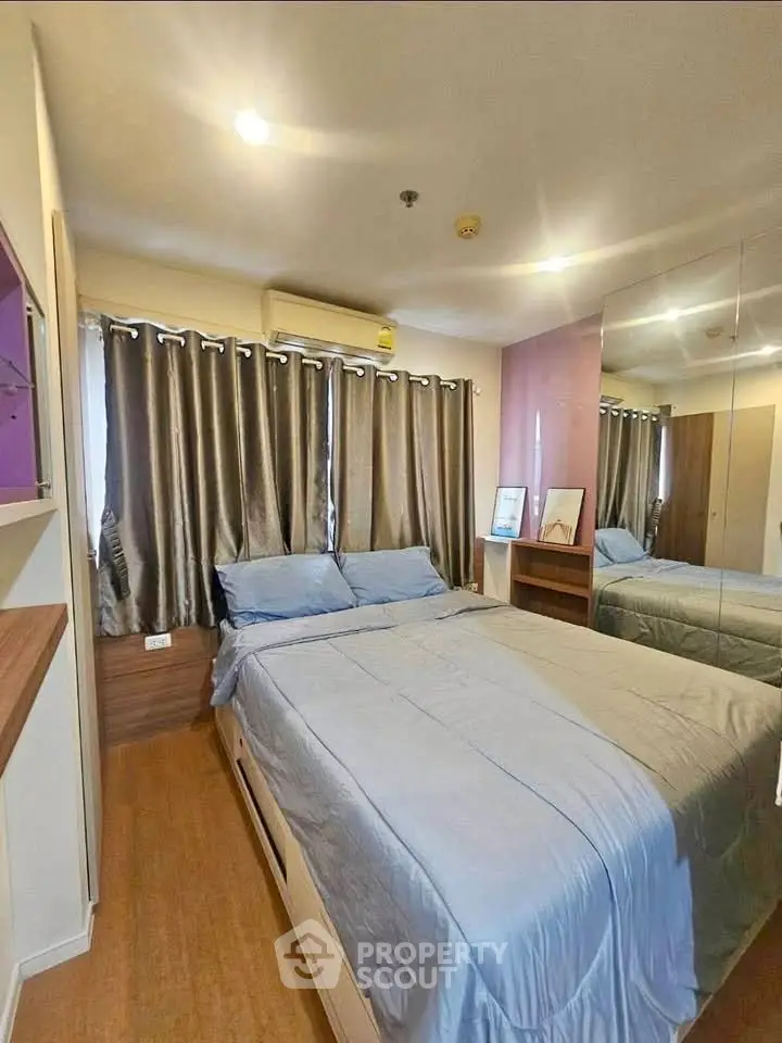 Cozy bedroom with modern decor and ample natural light.