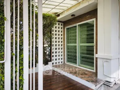 Charming balcony with wooden flooring and sliding glass doors, perfect for relaxation and outdoor enjoyment.